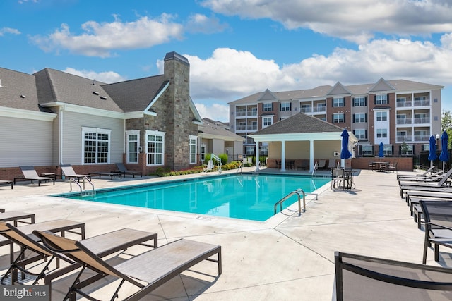 community pool featuring a patio area and fence