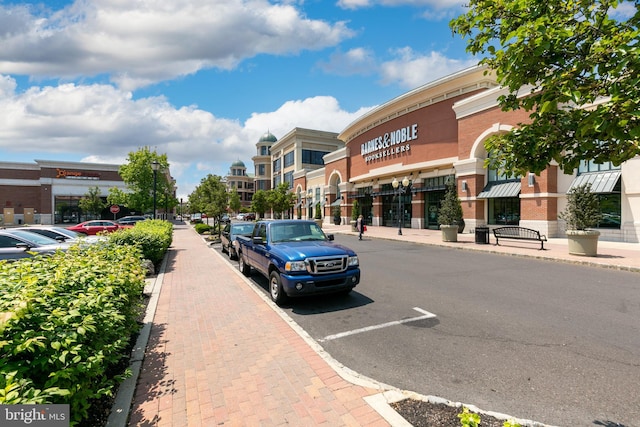 view of road featuring curbs, street lighting, and sidewalks