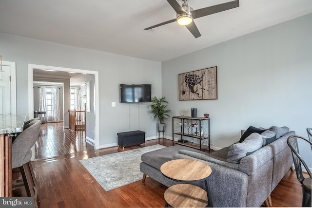 living room with ceiling fan, wood finished floors, and baseboards