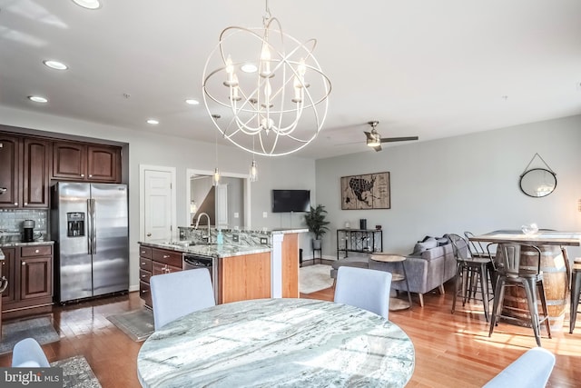 dining room featuring baseboards, ceiling fan with notable chandelier, wood finished floors, and recessed lighting