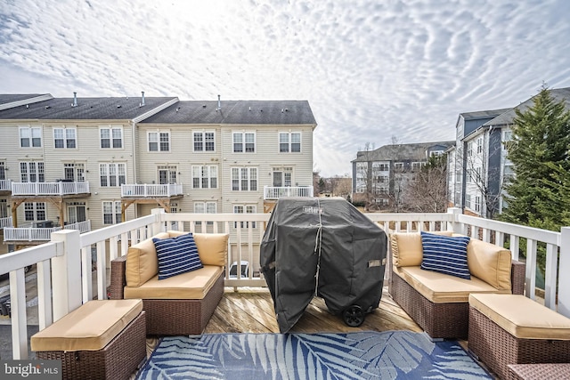 wooden deck featuring area for grilling and an outdoor living space