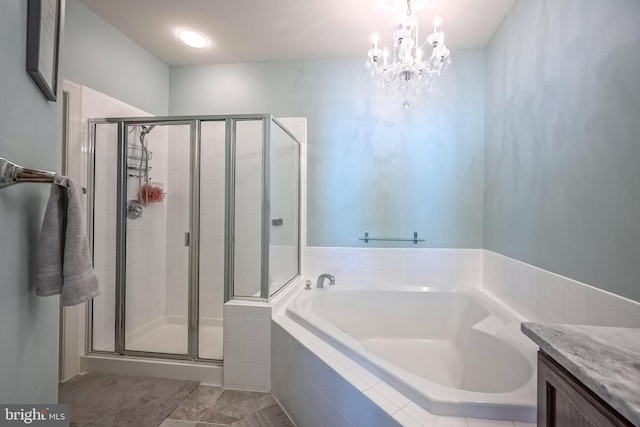 full bath with a chandelier, tile patterned flooring, a garden tub, vanity, and a stall shower