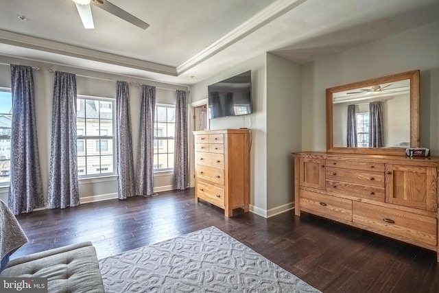 living area featuring a tray ceiling, dark wood-style flooring, ceiling fan, and baseboards