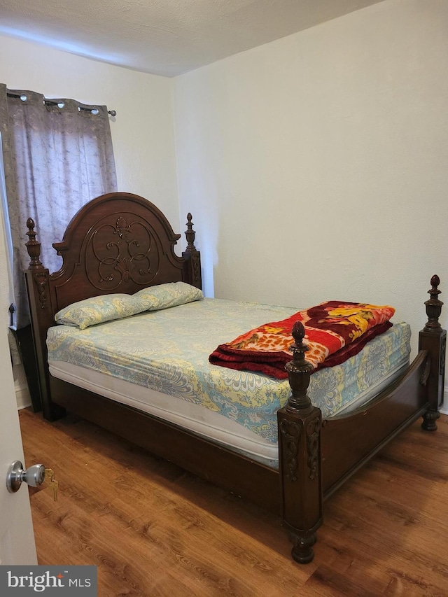 bedroom with wood finished floors