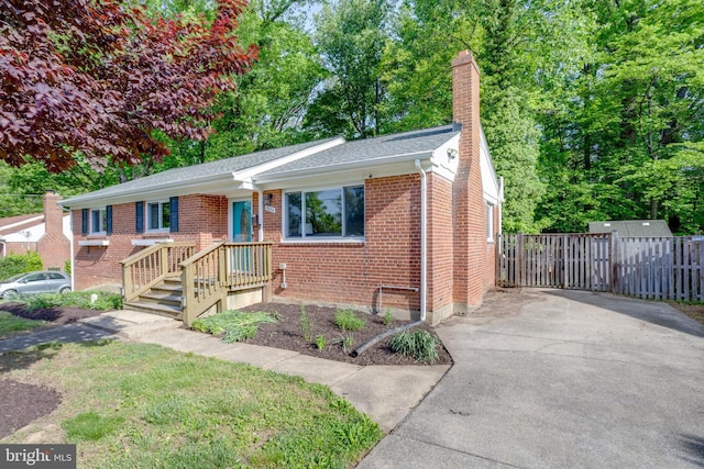 7424 Nancemond St, Springfield, VA 22150 - ranch-style house with fence, roof with shingles, a chimney, brick siding, and driveway