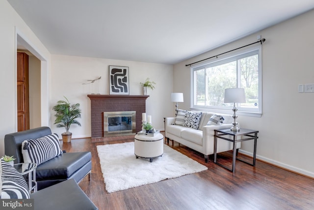 7424 Nancemond St, Springfield, VA 22150 - living room featuring baseboards, a brick fireplace, and wood finished floors