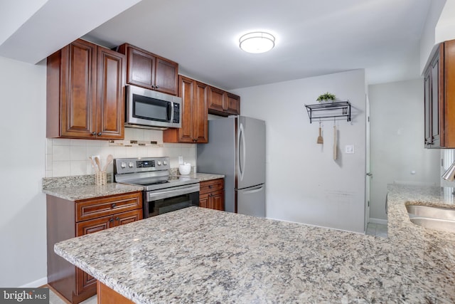 7424 Nancemond St, Springfield, VA 22150 - kitchen featuring a peninsula, light stone countertops, baseboards, appliances with stainless steel finishes, and backsplash