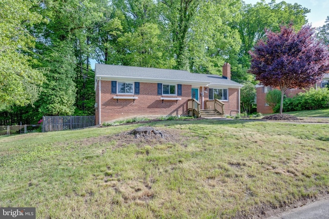 7424 Nancemond St, Springfield, VA 22150 - ranch-style home featuring brick siding, fence, a front yard, and a chimney