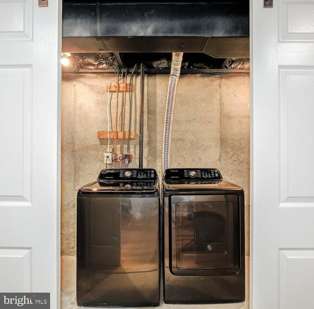 clothes washing area with washer and dryer