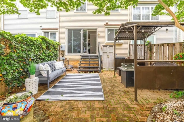 back of property featuring an outdoor living space, entry steps, a patio area, and fence