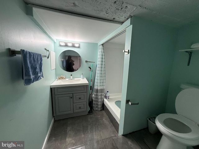 bathroom with toilet, wood finished floors, vanity, baseboards, and shower / bath combo