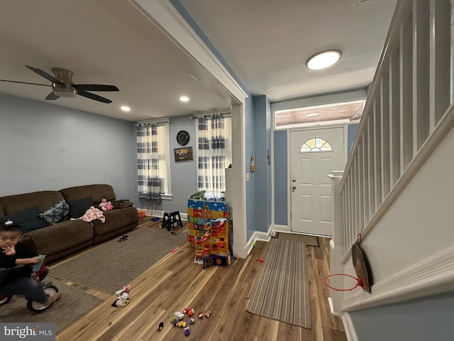 foyer entrance with recessed lighting, a ceiling fan, wood finished floors, baseboards, and stairs