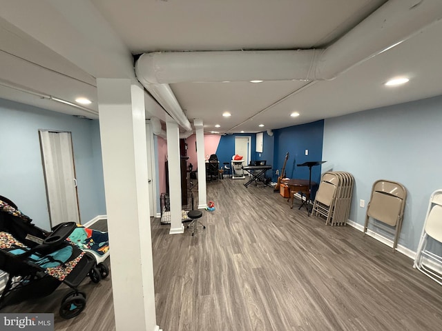 interior space with baseboards, wood finished floors, and recessed lighting