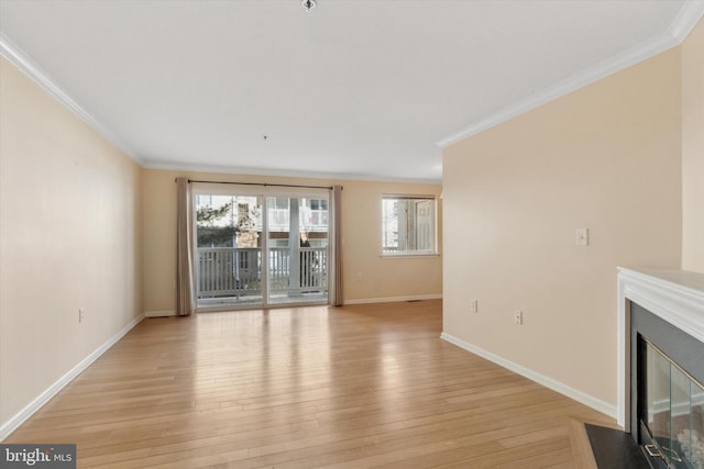 unfurnished living room featuring light wood-style floors, a fireplace with flush hearth, ornamental molding, and baseboards