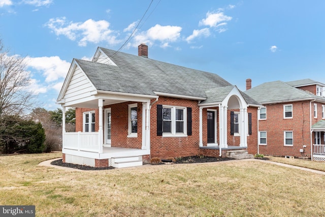 bungalow featuring a porch, a front yard, brick siding, and a chimney