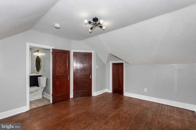 bonus room with lofted ceiling, dark wood-style flooring, and baseboards