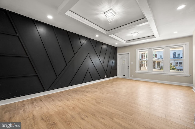 unfurnished room featuring baseboards, a raised ceiling, crown molding, light wood-style floors, and recessed lighting