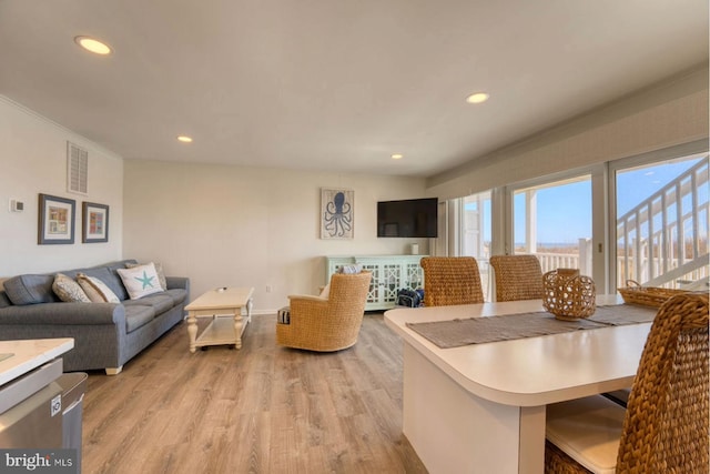 interior space with light wood-style flooring, visible vents, baseboards, and recessed lighting