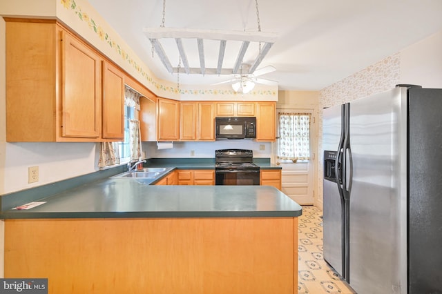 kitchen featuring dark countertops, ceiling fan, a peninsula, and black appliances