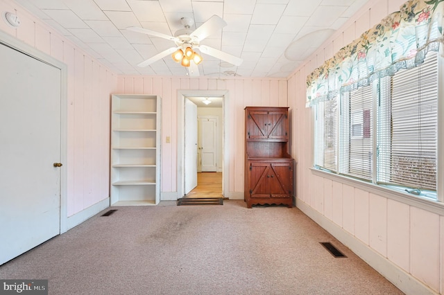 unfurnished bedroom featuring visible vents and light colored carpet