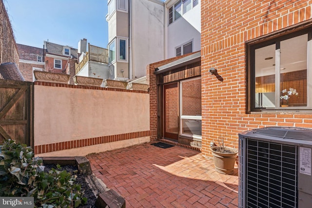 view of patio / terrace with central AC unit and fence