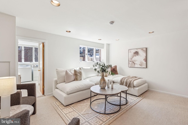 living room featuring recessed lighting, light colored carpet, baseboards, and washer and clothes dryer