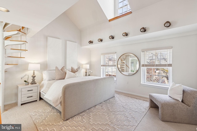 bedroom featuring vaulted ceiling, light colored carpet, and baseboards