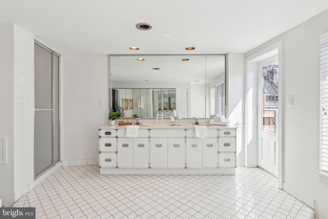 bathroom featuring recessed lighting, a shower stall, and vanity