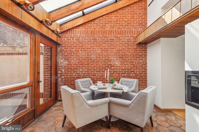 sunroom featuring vaulted ceiling with beams