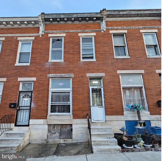 view of front of home featuring entry steps and brick siding