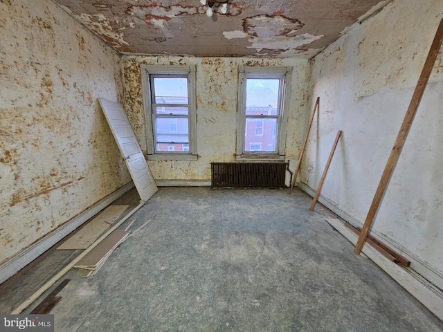 spare room featuring radiator heating unit