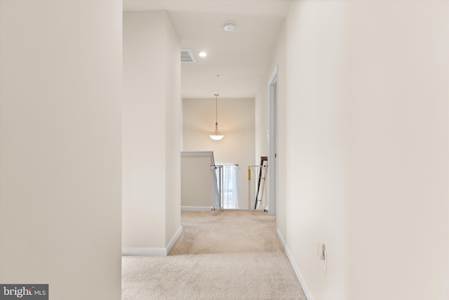 corridor featuring recessed lighting, visible vents, light carpet, an upstairs landing, and baseboards