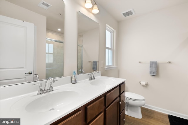 full bath featuring baseboards, visible vents, a sink, and toilet