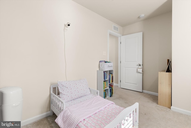 bedroom featuring visible vents, baseboards, and light colored carpet