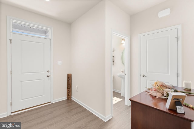 entrance foyer with light wood-type flooring and baseboards