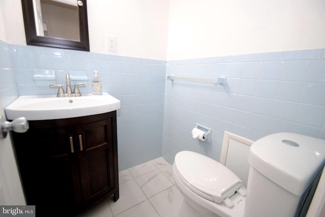 307 Broad St, Hainesport, NJ 08036 - bathroom with toilet, vanity, wainscoting, marble finish floor, and tile walls