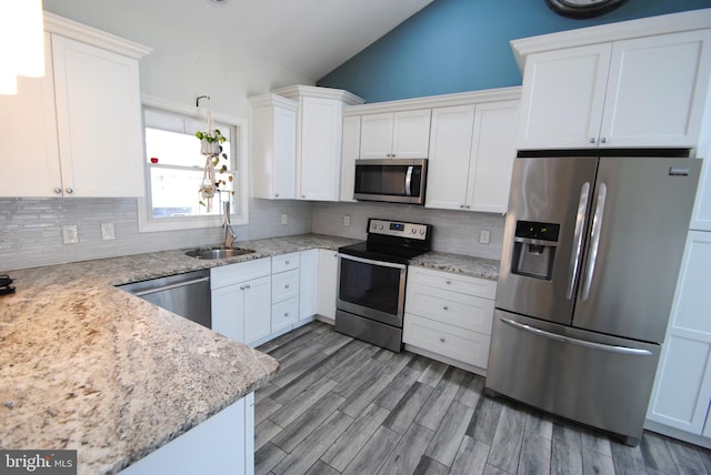 307 Broad St, Hainesport, NJ 08036 - kitchen featuring vaulted ceiling, a sink, stainless steel appliances, and backsplash