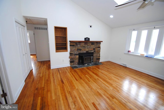307 Broad St, Hainesport, NJ 08036 - living room with light wood finished floors, visible vents, ceiling fan, and a wood stove