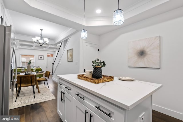 kitchen featuring stainless steel refrigerator with ice dispenser, a kitchen island, light stone countertops, and white cabinets