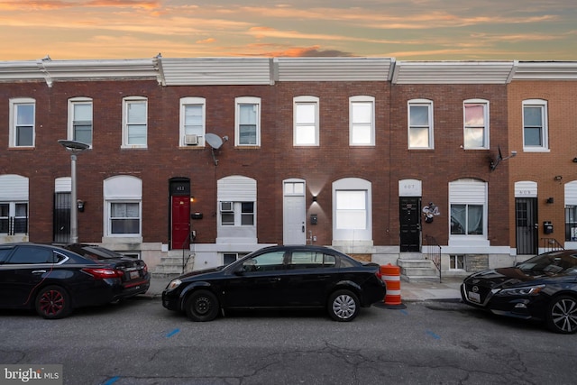 view of front of property with entry steps and brick siding