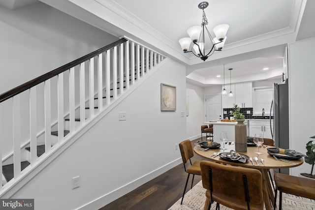 dining area with baseboards, a raised ceiling, dark wood-style flooring, crown molding, and recessed lighting