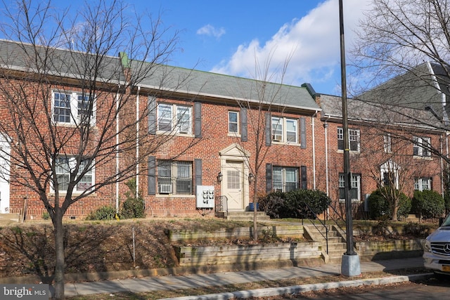 view of property with brick siding