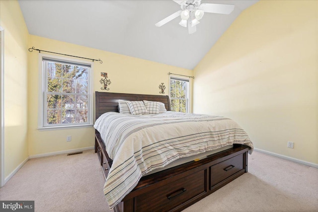 bedroom featuring lofted ceiling, baseboards, and light colored carpet