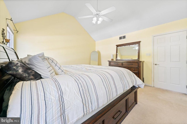 bedroom with light carpet, visible vents, vaulted ceiling, and a ceiling fan