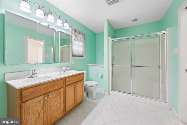 bathroom with a sink, visible vents, and a shower stall