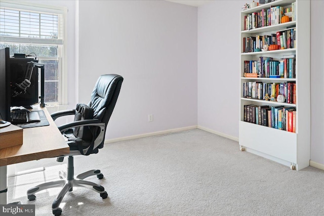 office featuring baseboards and light colored carpet