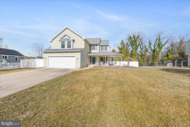 view of front of home featuring driveway, covered porch, fence, and a front yard