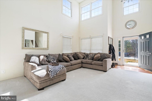 carpeted living area with baseboards