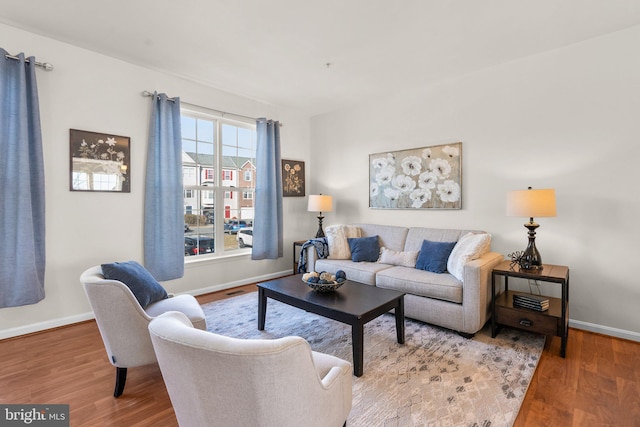 living room with baseboards and wood finished floors