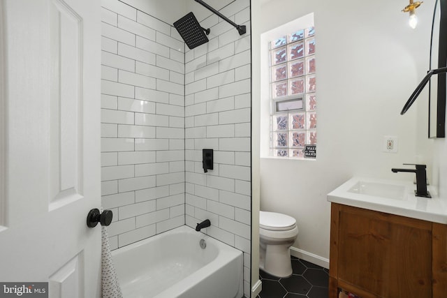 bathroom featuring baseboards, toilet, tile patterned flooring, bathtub / shower combination, and vanity